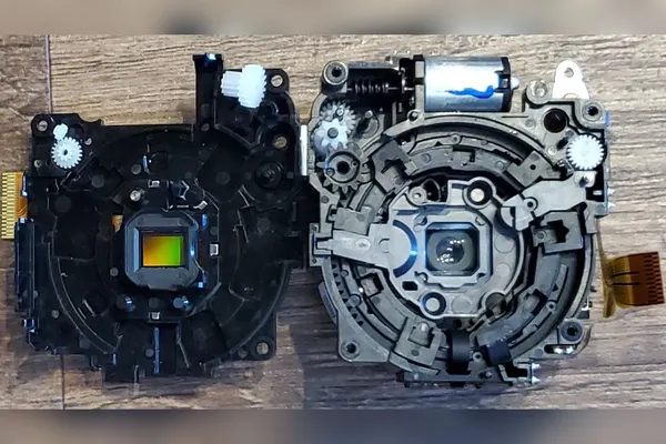 Camera lens mechanism taken apart, showing the image sensor